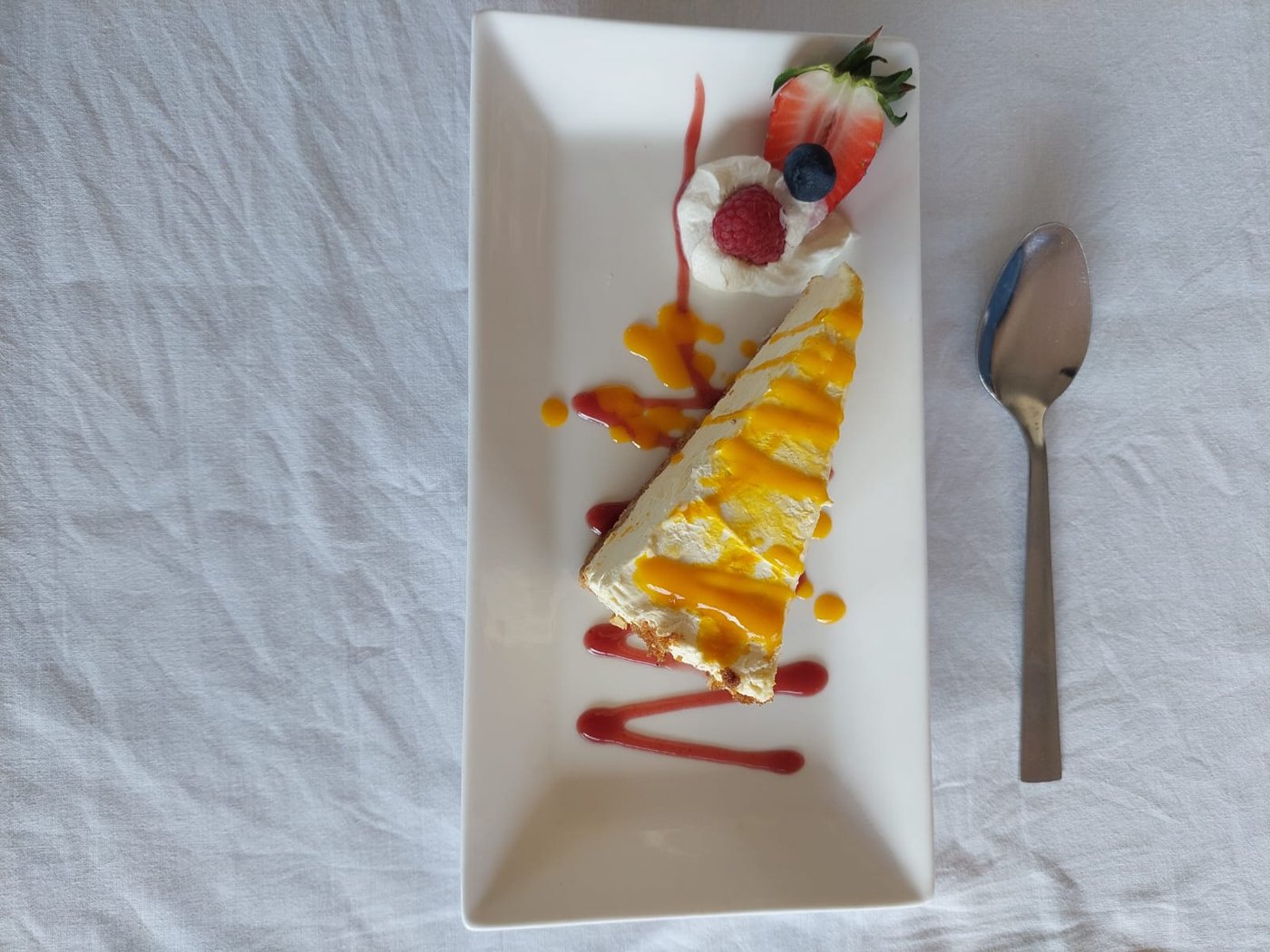 Cold dessert of the day — homemade cheesecake with mango coulis at TMT Café Bistro, Scottish Borders